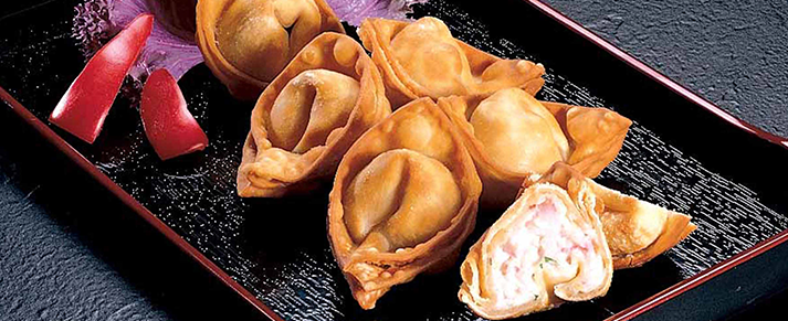 Plate of foodservice Amoy Asian Crab Rangoons in a restaurant setting