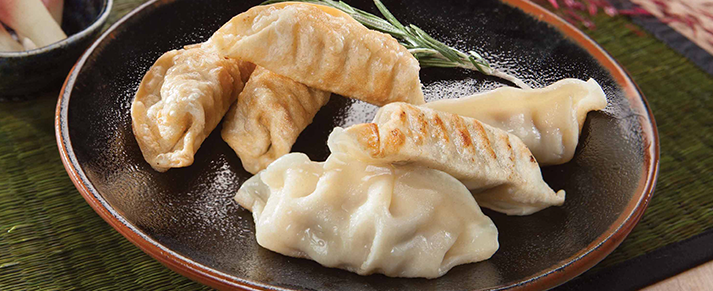 Plate of foodservice Amoy Asian Pork Potstickers in a restaurant setting