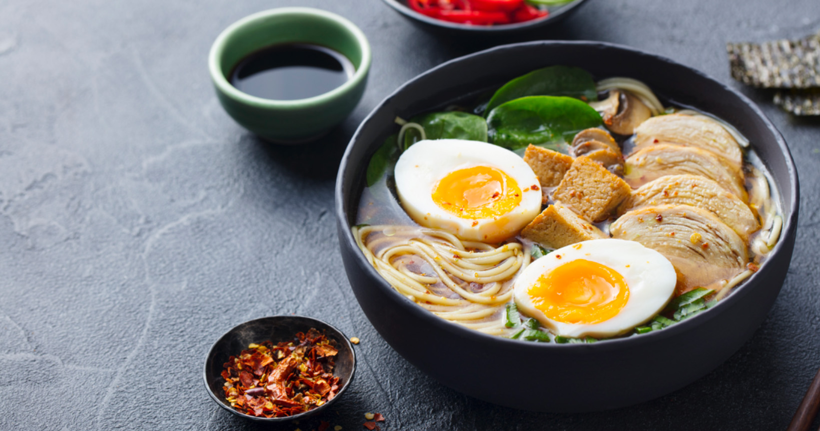 bowl of chow main noodles with boiled egg and pork protein