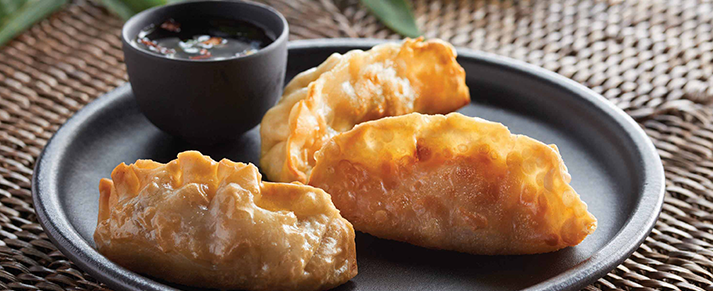 Plate of foodservice Amoy Asian Vegetable Potstickers in a restaurant setting